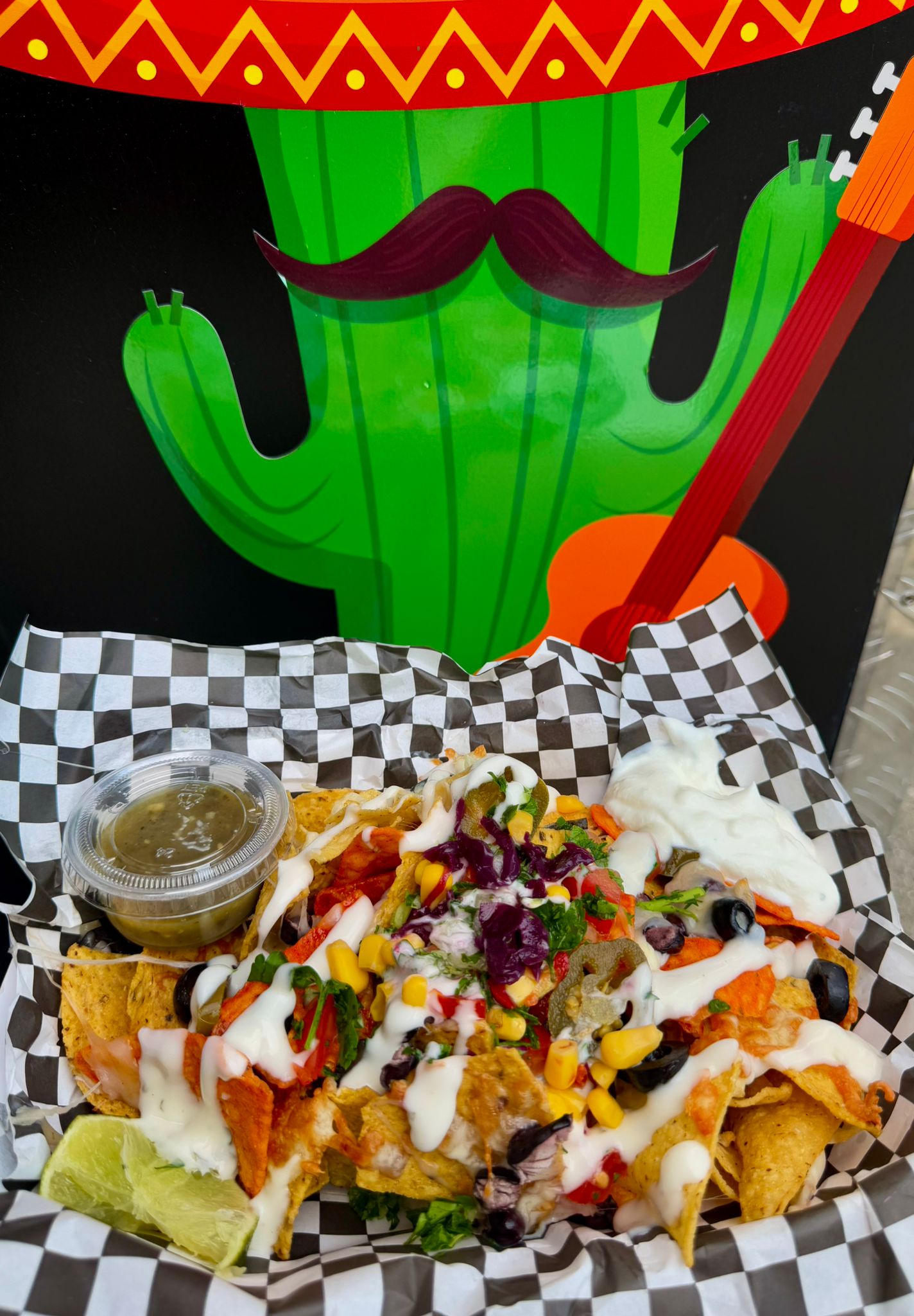 Tackia loaded nachos with guacamole, sour cream, olives, corn and fresh toppings